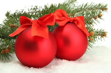 Christmas balls on fir tree with snow, isolated on white