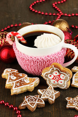 Cup of coffee with Christmas sweetness on wooden table close-up