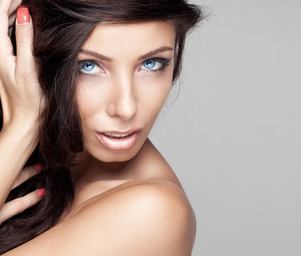 Portrait of beautiful brunette woman with blue eyes