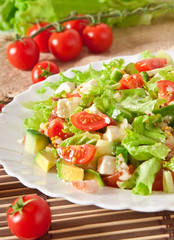 Salad with avocado, cherry tomatoes and mozzarella 