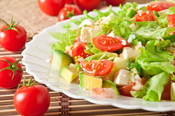 Salad with avocado, cherry tomatoes and mozzarella 