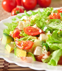 Salad with avocado, cherry tomatoes and mozzarella 