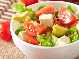 Salad with avocado, cherry tomatoes and mozzarella 