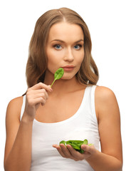 woman with spinach leaves on palms