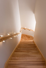 Wooden staircase decorated with lights