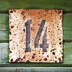 Vintage wooden wall with grunge house number