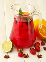 sangria in jar with fruits, on white wooden table