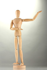 wooden mannequin, on grey background