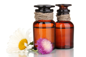 medicine bottles and flowers isolated on white