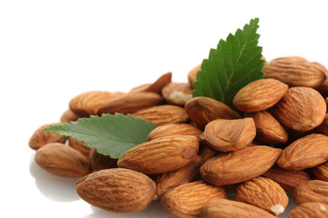 tasty almonds nuts with leaves, isolated on white