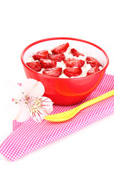 Cottage cheese in red bowl with sliced strawberries isolated