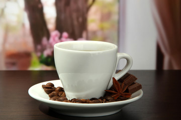cup of coffee with beans on table in cafe