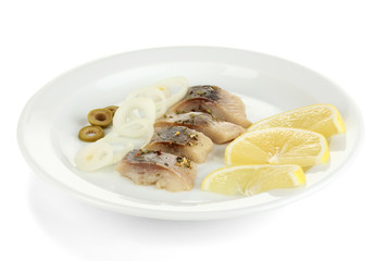 Dish of herring and lemon on plate isolated on white