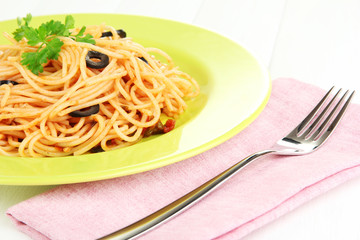 Italian spaghetti in plate on wooden table