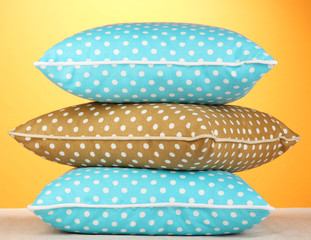 Fototapeta premium Blue bright pillows on orange background