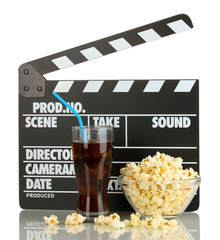 Movie clapperboard, cola and popcorn isolated on white