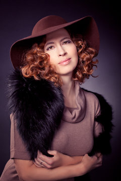 Red haired woma wearing elegant brown felt hat