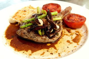 Grilled pork chop and tomatoes with potato mash and asparagus. H
