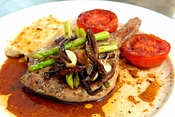 Grilled pork chop and tomatoes with potato mash and asparagus. H