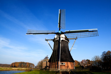 Fototapeta na wymiar Dutch windmill over blue sky