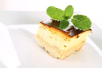 Piece of cheesecake decorated with mint