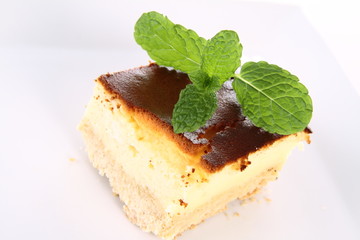Piece of cheesecake decorated with mint