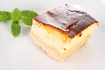 Piece of cheesecake decorated with mint