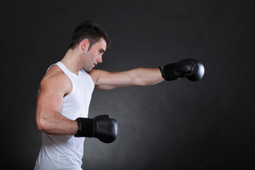 Fototapeta na wymiar Portrait sportsman boxer in studio dark background