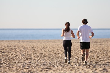 Man and woman running in the beach
