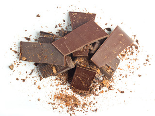chocolate pieces with nuts on white background top view