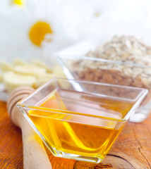 Honey in the glass bowl on the wooden table