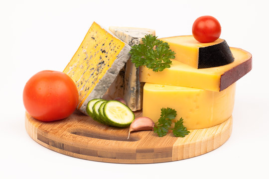Various types of cheese on wooden plate isolated on white