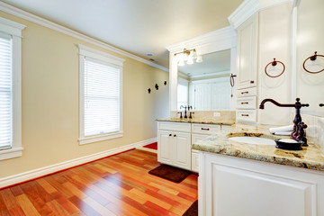 Luxury large white master bathroom with cherry hardwood.