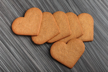 Cookies in shape of a heart on wooden table.