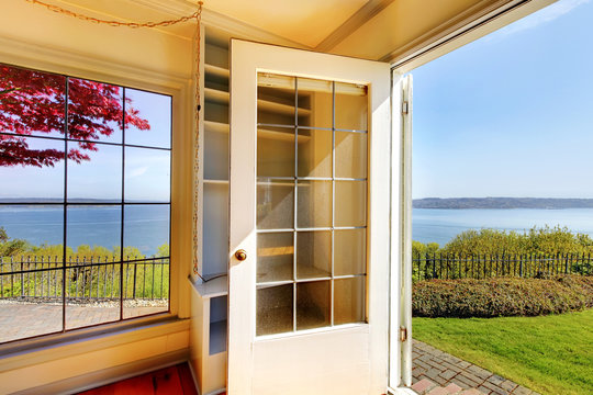 Open door from the living room to the back yard with water view.