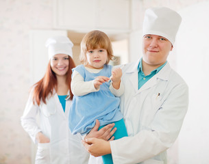 Doctor and nurse with child at  clinic