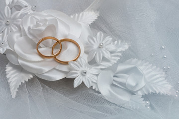 Two wedding rings and wedding background