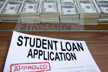 Approved student loan application and dollar bills