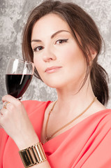 Portrait of beautiful woman, holding glass of red wine