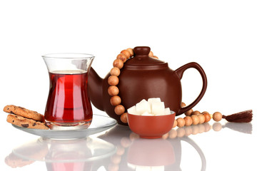 glass of Turkish tea and kettle isolated on white