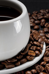 A cup of coffee on a background coffee grains