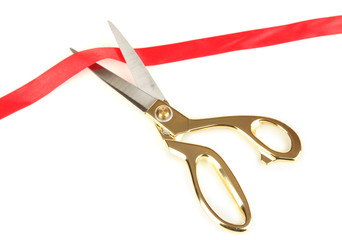 Cutting red ribbon isolated on white