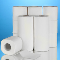Rolls of toilet paper on blue background