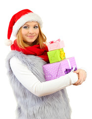 Attractive young woman holding Christmas gifts, isolated