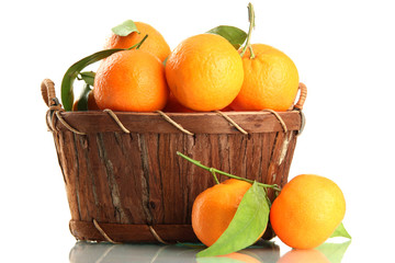 Ripe sweet tangerine with leaves in basket, isolated on white