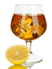 Glass of brandy with ice and lemon isolated on white