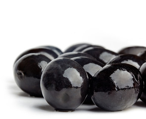 black olives closeup photo on white