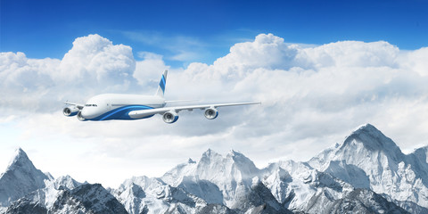 Fototapeta premium White passenger plane above the mountains