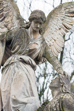 statue in a cemetery at fall