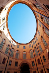 oval blue sky in in Italian urban court
